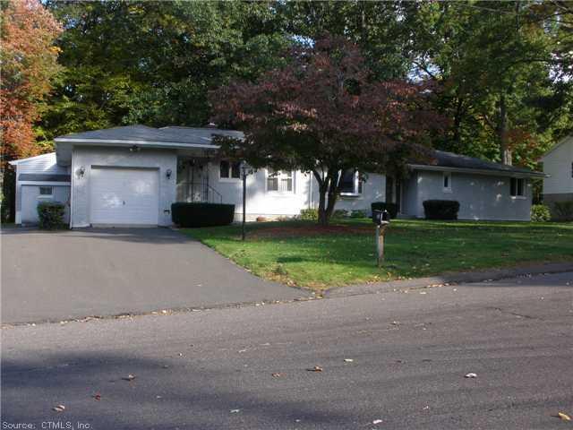 a front view of a house with a yard and a garage