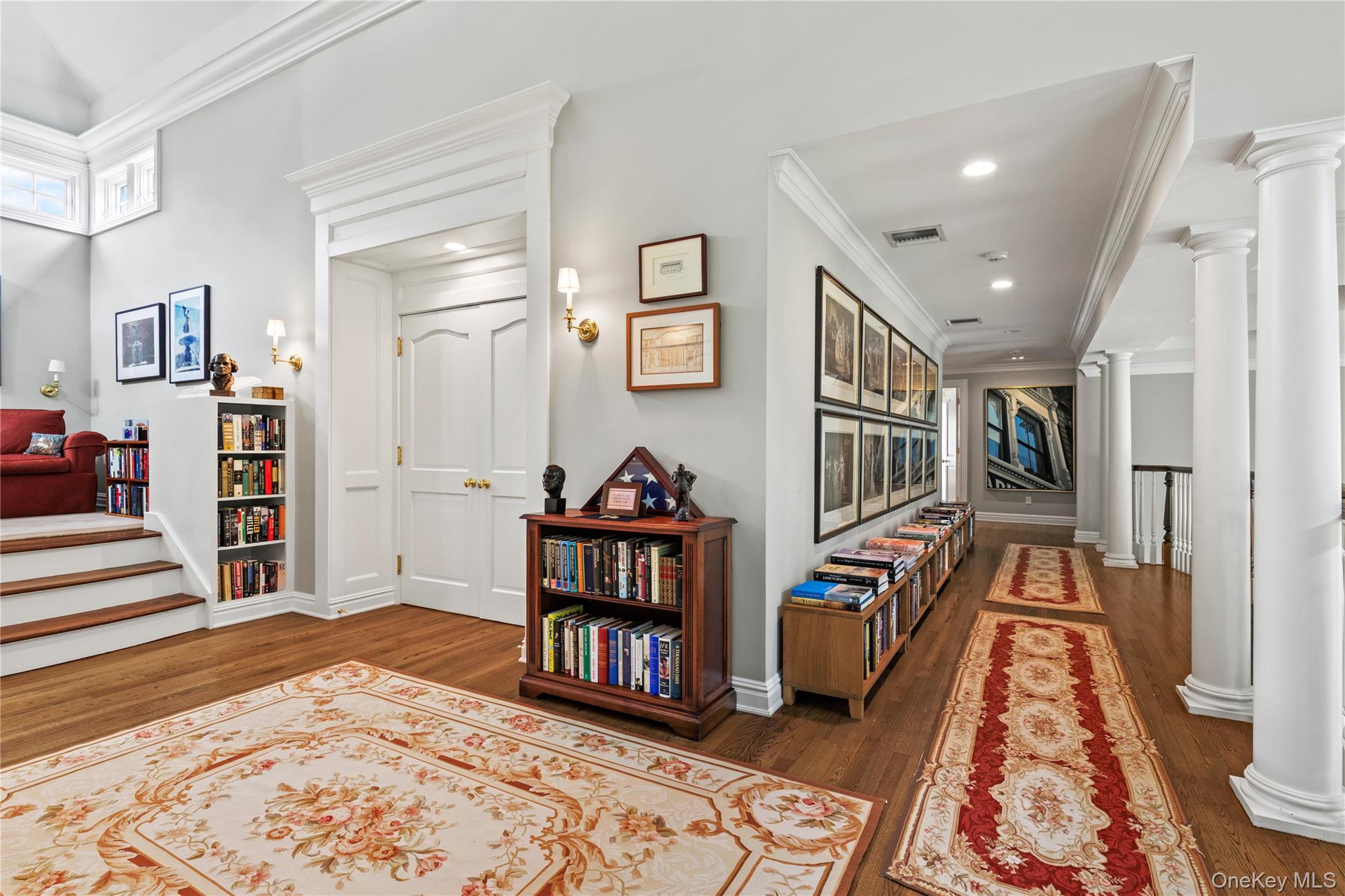 63 Old Mill River Road Pound Ridge, NY 10576 - Photo 19 of 47 a view of a hallway with wooden floor and windows