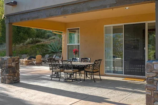 a view of backyard with seating space and trees