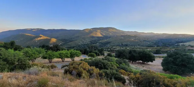 a view of a town with mountains in the background