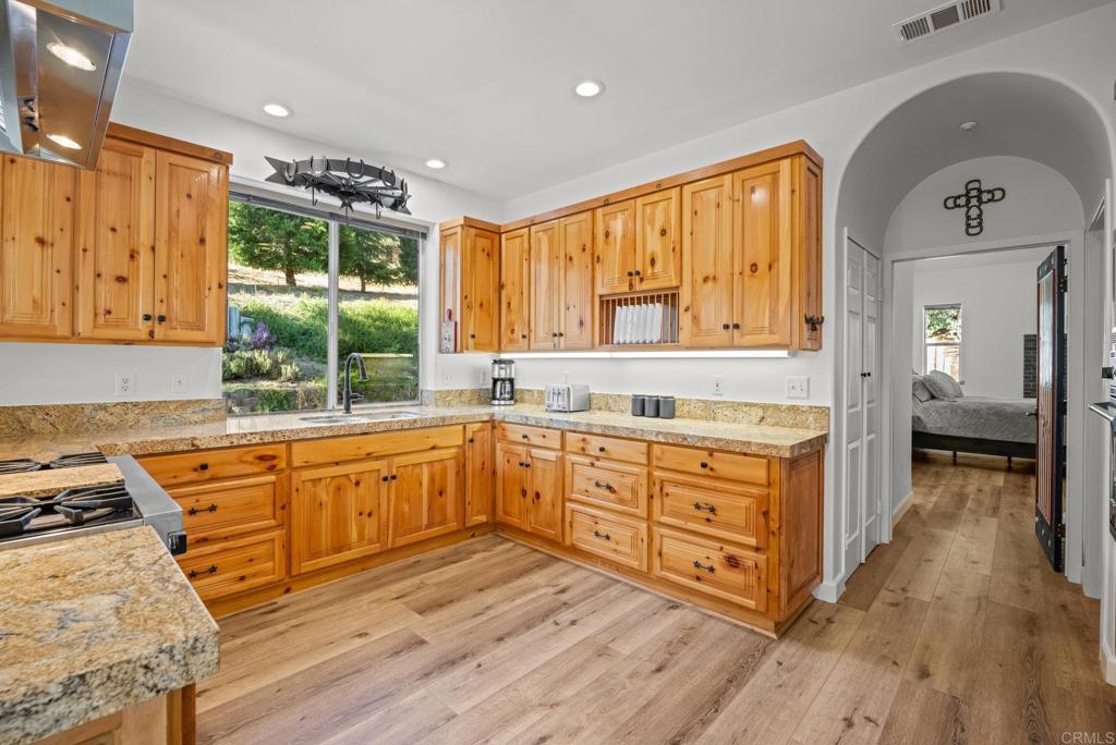 26380 San Felipe Road Warner Springs, CA 92086 - Photo 22 of 69 a large kitchen with kitchen island granite countertop wooden floors and wide window