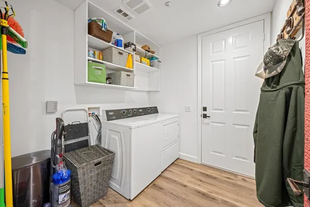 a spacious bathroom with a granite countertop double vanity sink and a mirror
