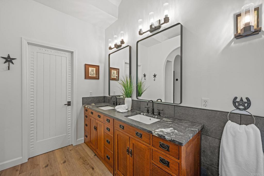 26380 San Felipe Road Warner Springs, CA 92086 - Photo 31 of 69 a spacious bathroom with a granite countertop double vanity sink and a mirror