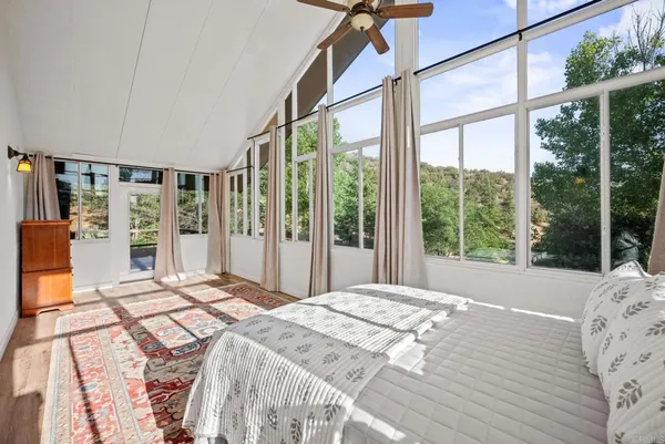 an aerial view of house with yard and mountain view in back