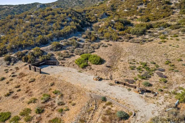 a view of a dry yard with mountains in the background