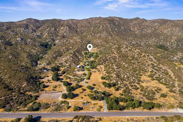 an aerial view of a house with mountain view
