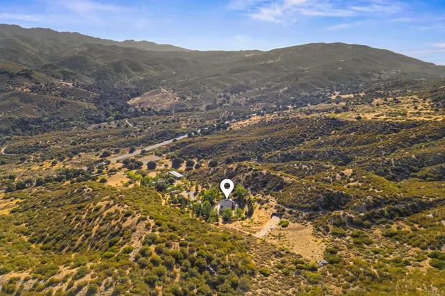 an aerial view of a house with mountain view