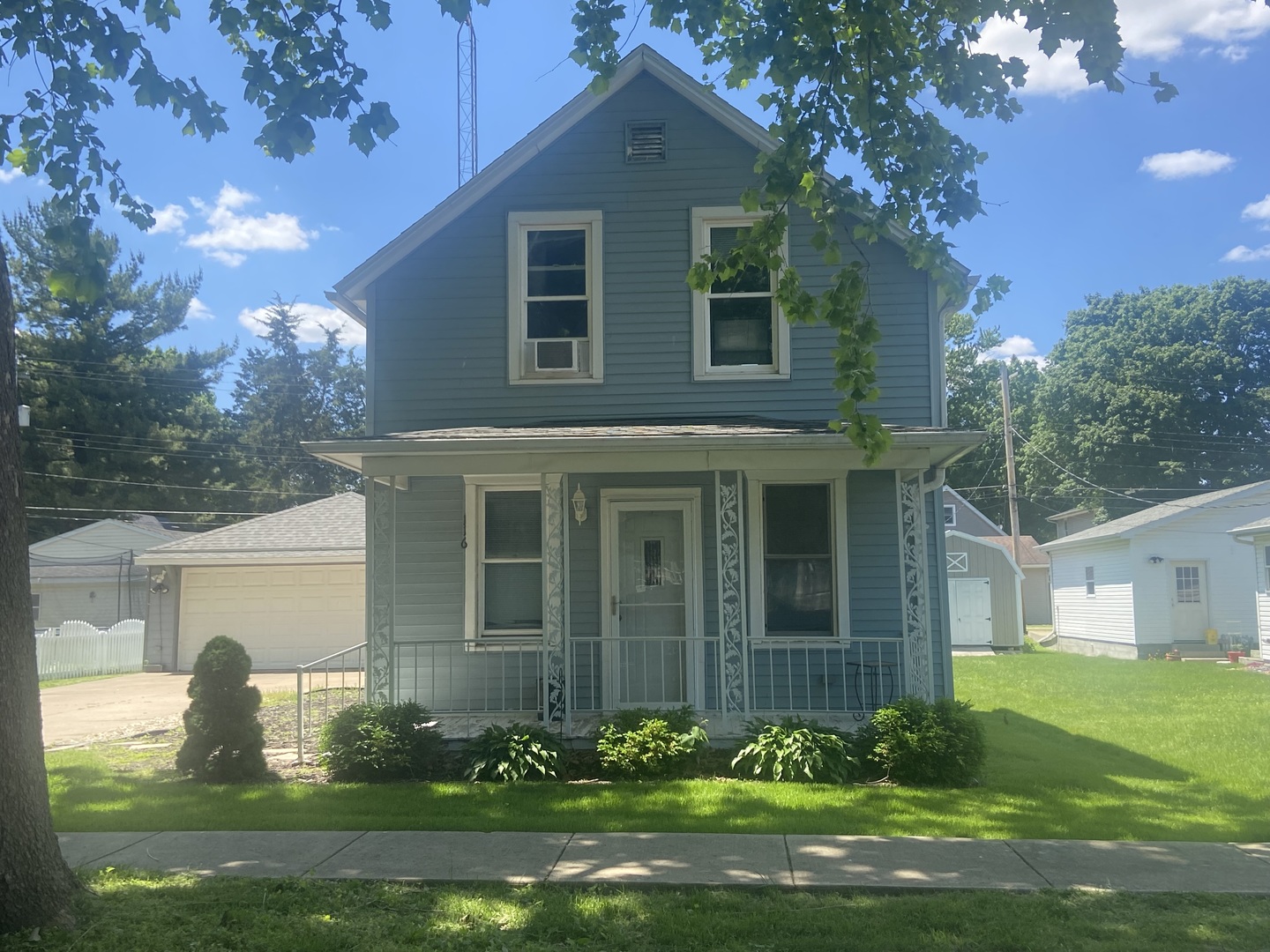 116 North Peru Avenue Ladd, IL 61329 - Photo 1 of 12 a front view of a house with a garden and plants