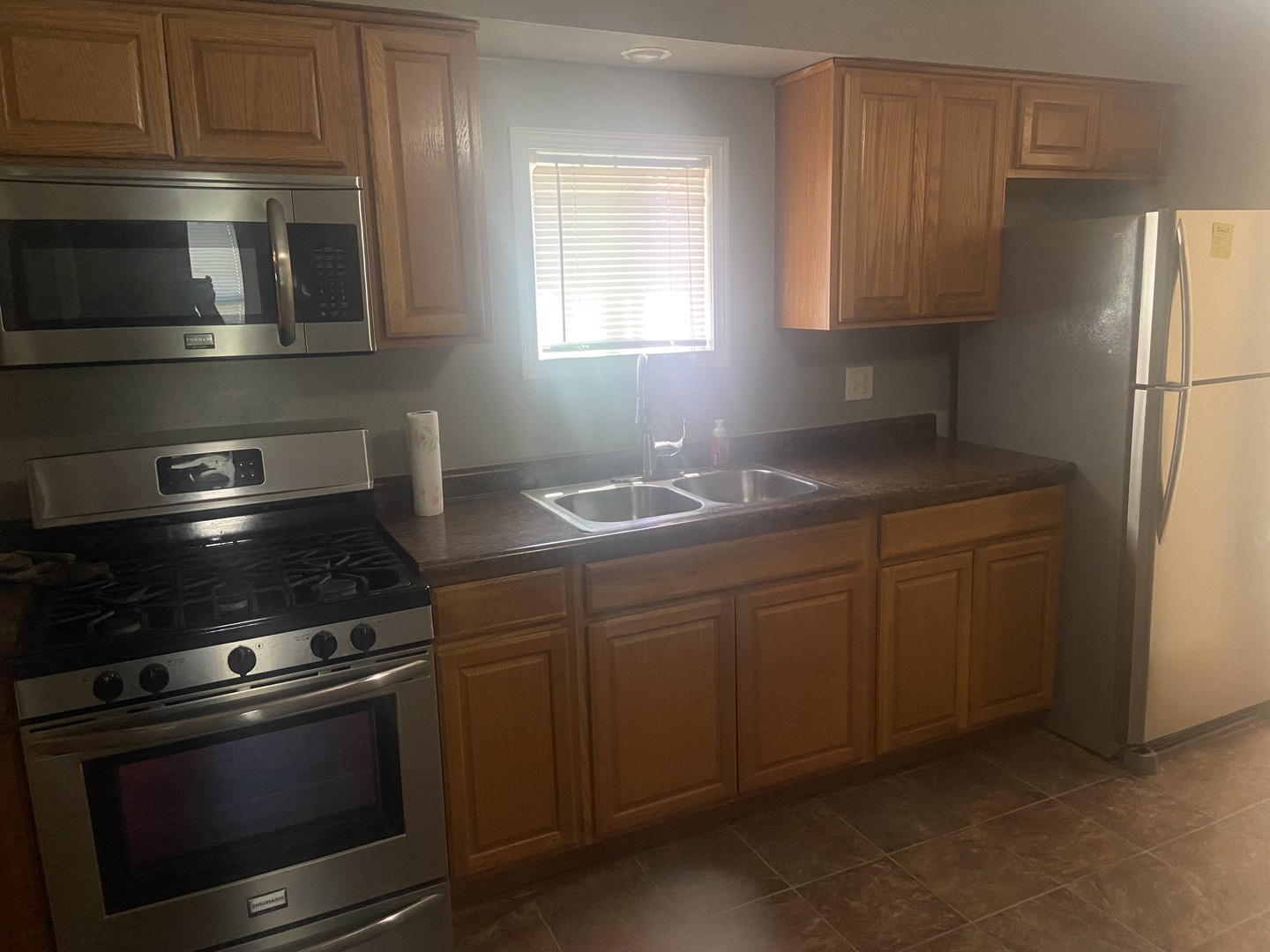 116 North Peru Avenue Ladd, IL 61329 - Photo 5 of 12 a kitchen with granite countertop a stove microwave and sink