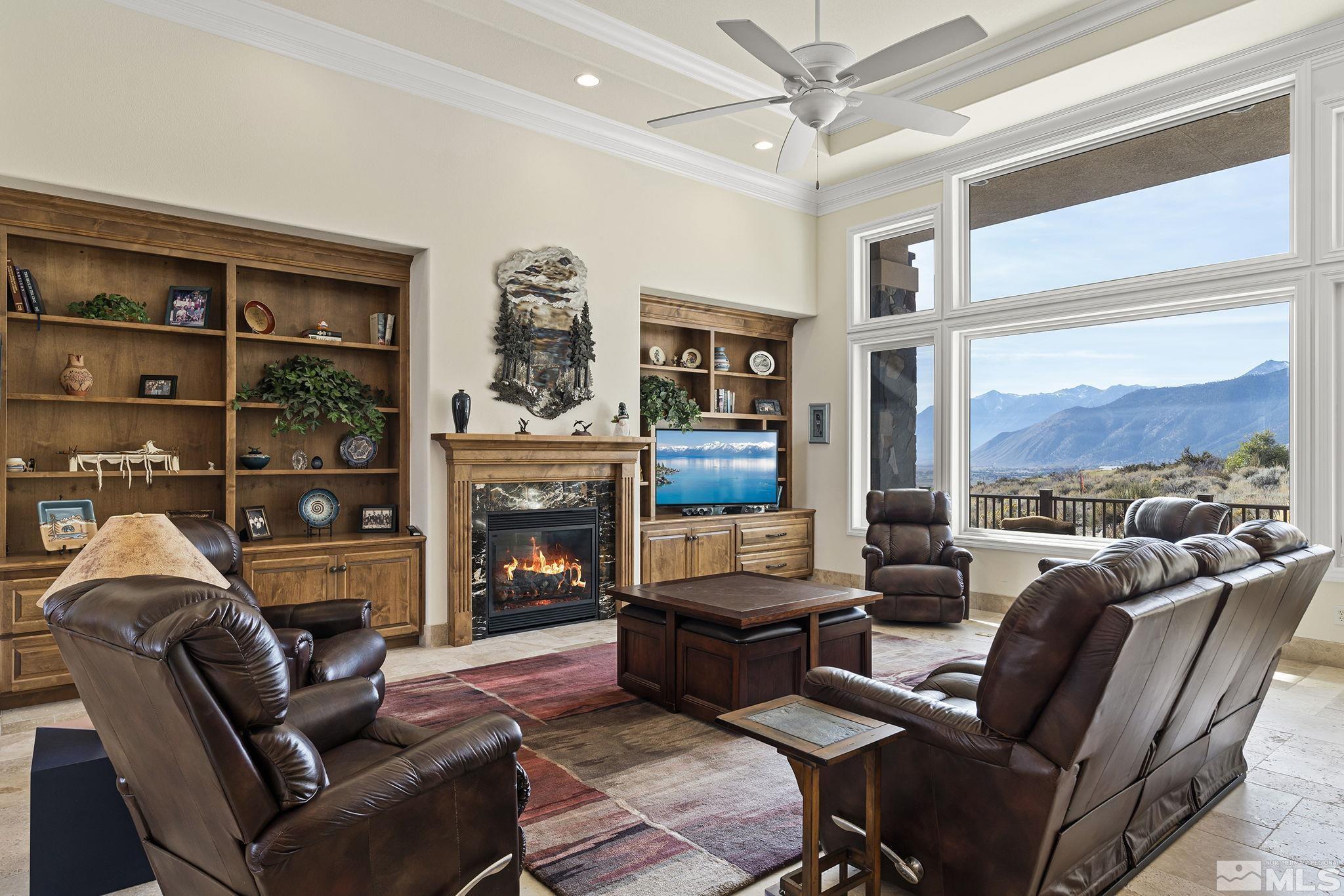 345 James Canyon Loop Genoa, NV 89411 - Photo 11 of 40 a living room with furniture a fireplace and a large window