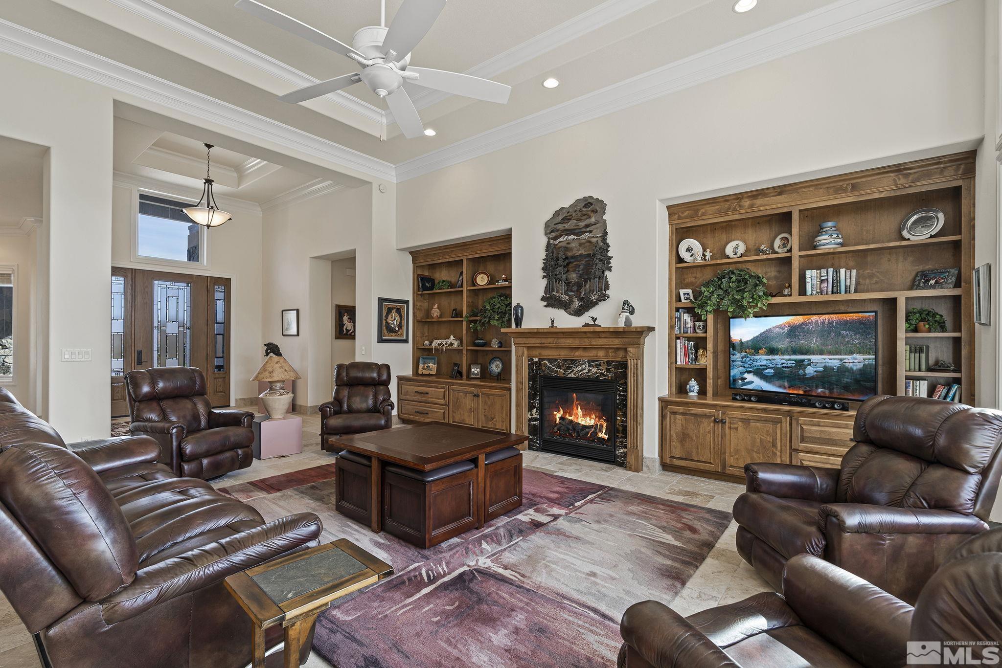 345 James Canyon Loop Genoa, NV 89411 - Photo 13 of 40 a living room with furniture a flat screen tv and a fireplace