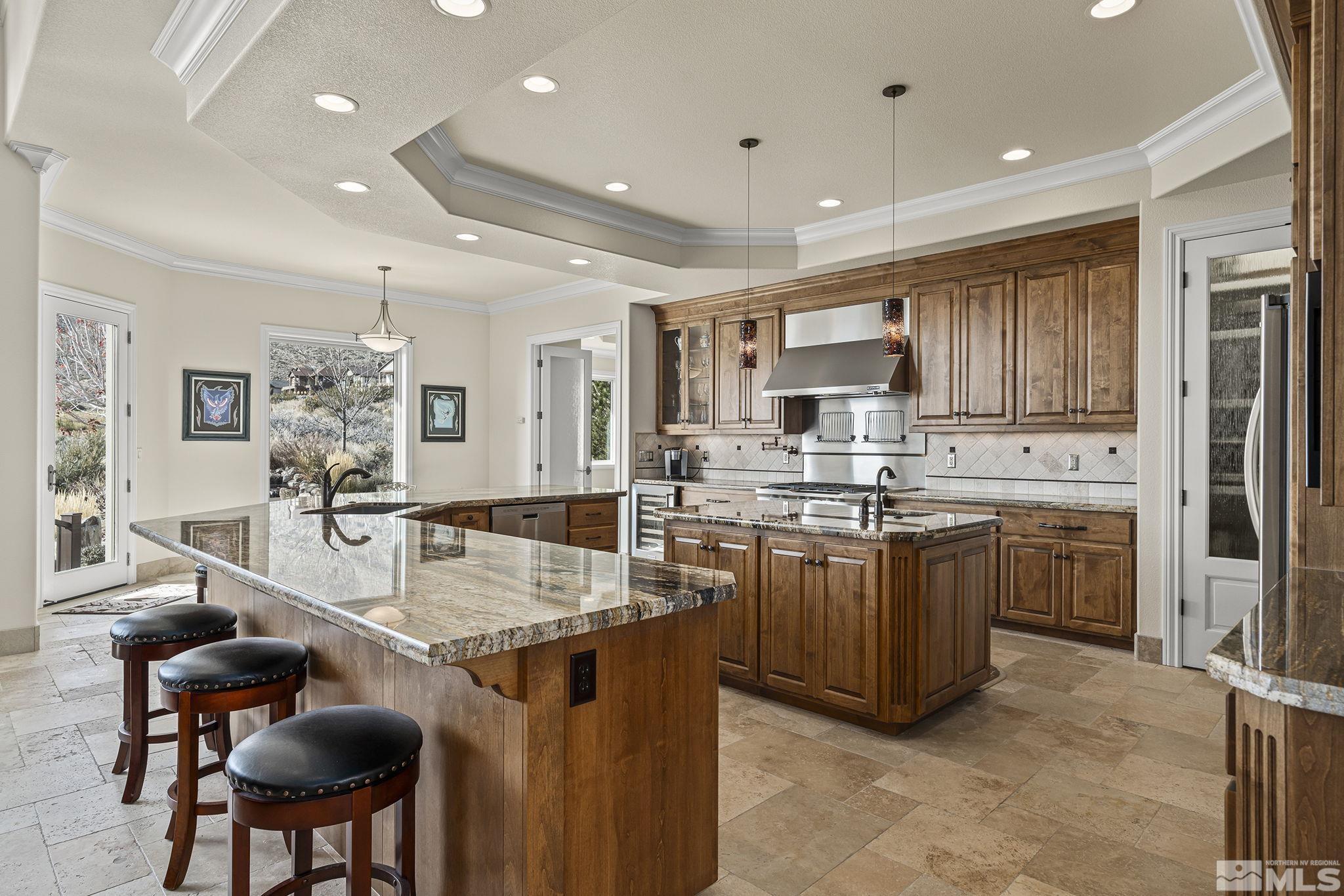 345 James Canyon Loop Genoa, NV 89411 - Photo 15 of 40 a kitchen with stainless steel appliances granite countertop a stove refrigerator and cabinets