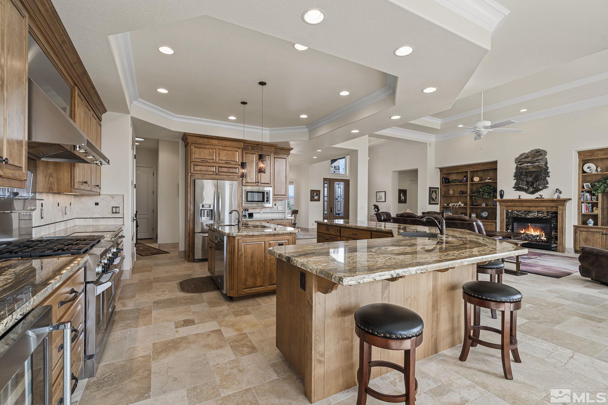 345 James Canyon Loop Genoa, NV 89411 - Photo 17 of 40 a kitchen with sink a stove and chairs