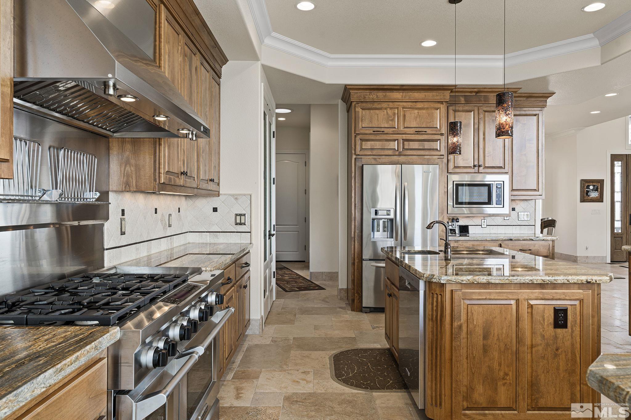 345 James Canyon Loop Genoa, NV 89411 - Photo 18 of 40 a kitchen with stainless steel appliances granite countertop a stove a sink dishwasher and a refrigerator