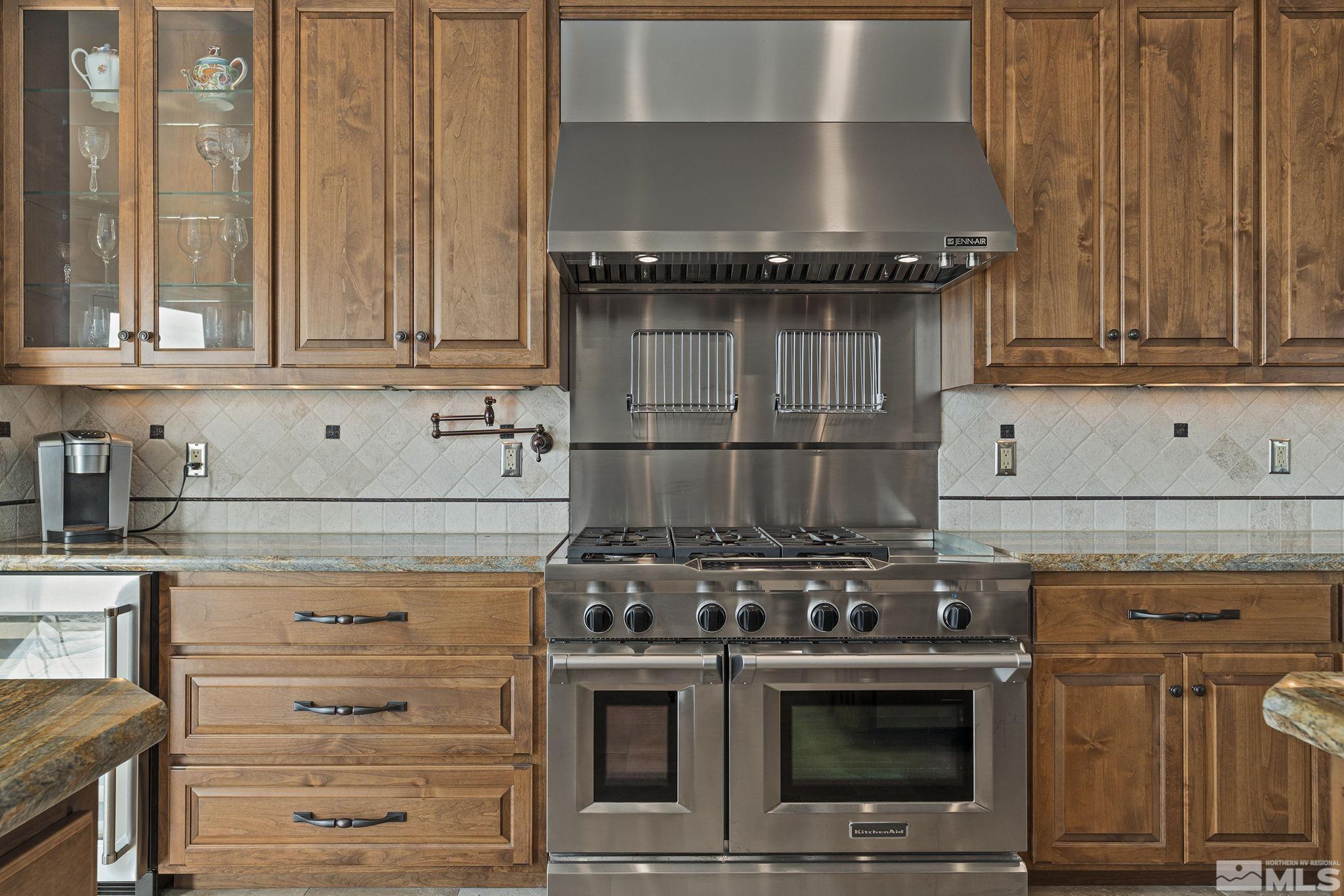 345 James Canyon Loop Genoa, NV 89411 - Photo 19 of 40 a kitchen with granite countertop a stove and a refrigerator