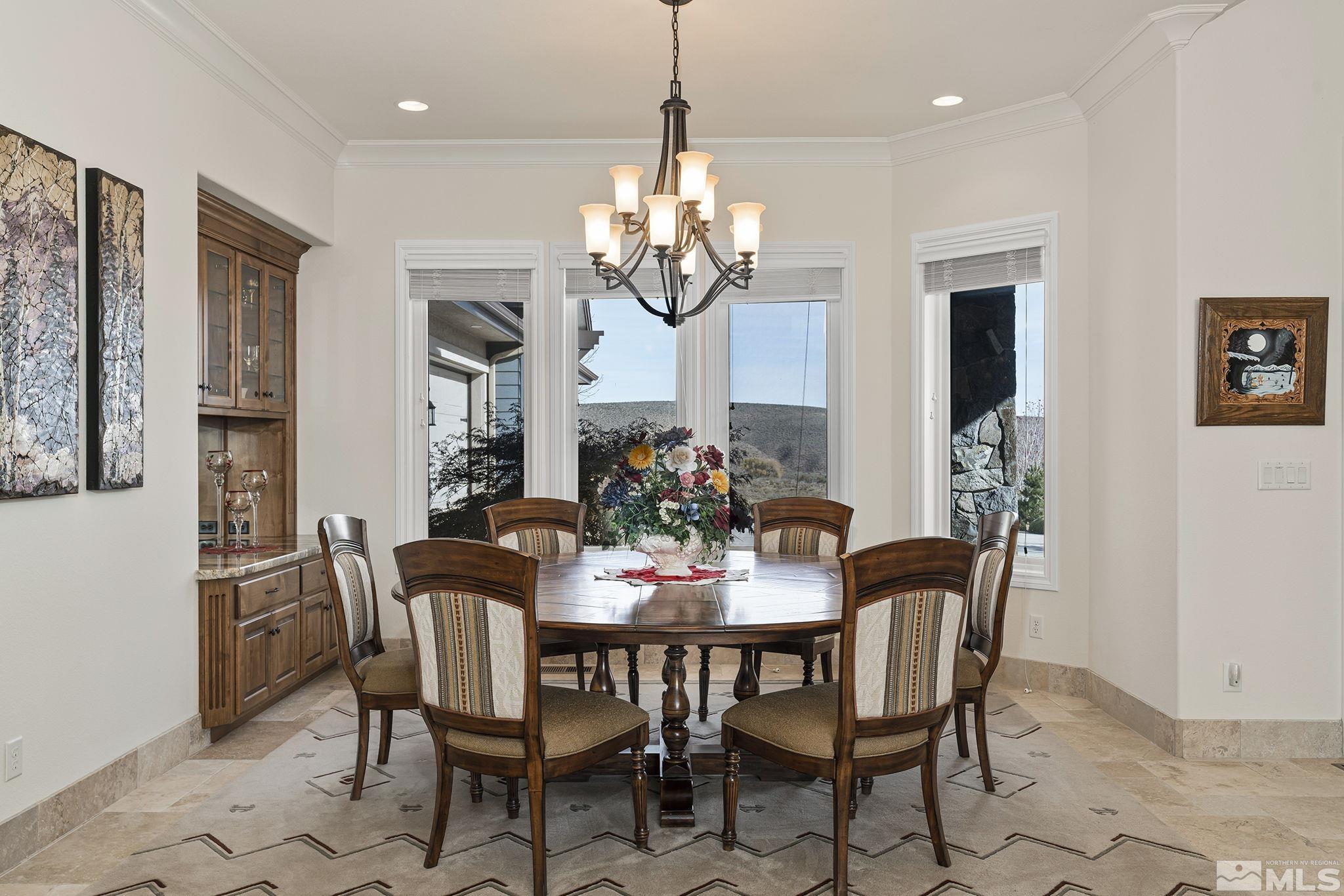 345 James Canyon Loop Genoa, NV 89411 - Photo 21 of 40 a view of a dining room with furniture a chandelier and wooden floor