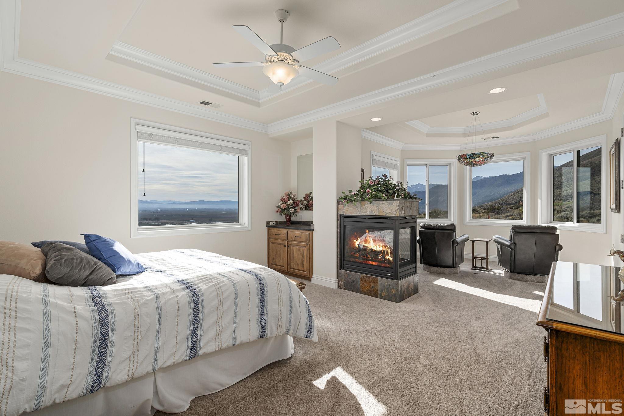 345 James Canyon Loop Genoa, NV 89411 - Photo 24 of 40 a bedroom with bed and a fireplace