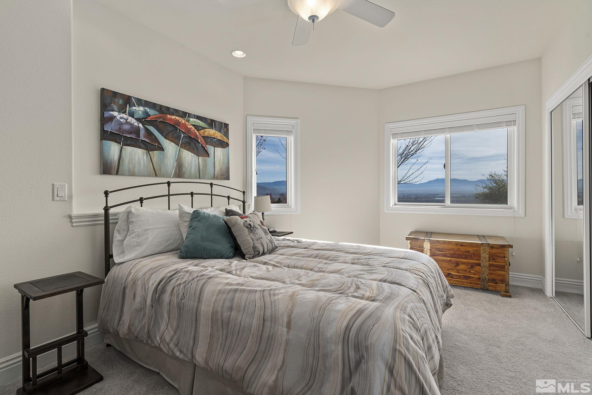345 James Canyon Loop Genoa, NV 89411 - Photo 27 of 40 a bedroom with a large bed and a window