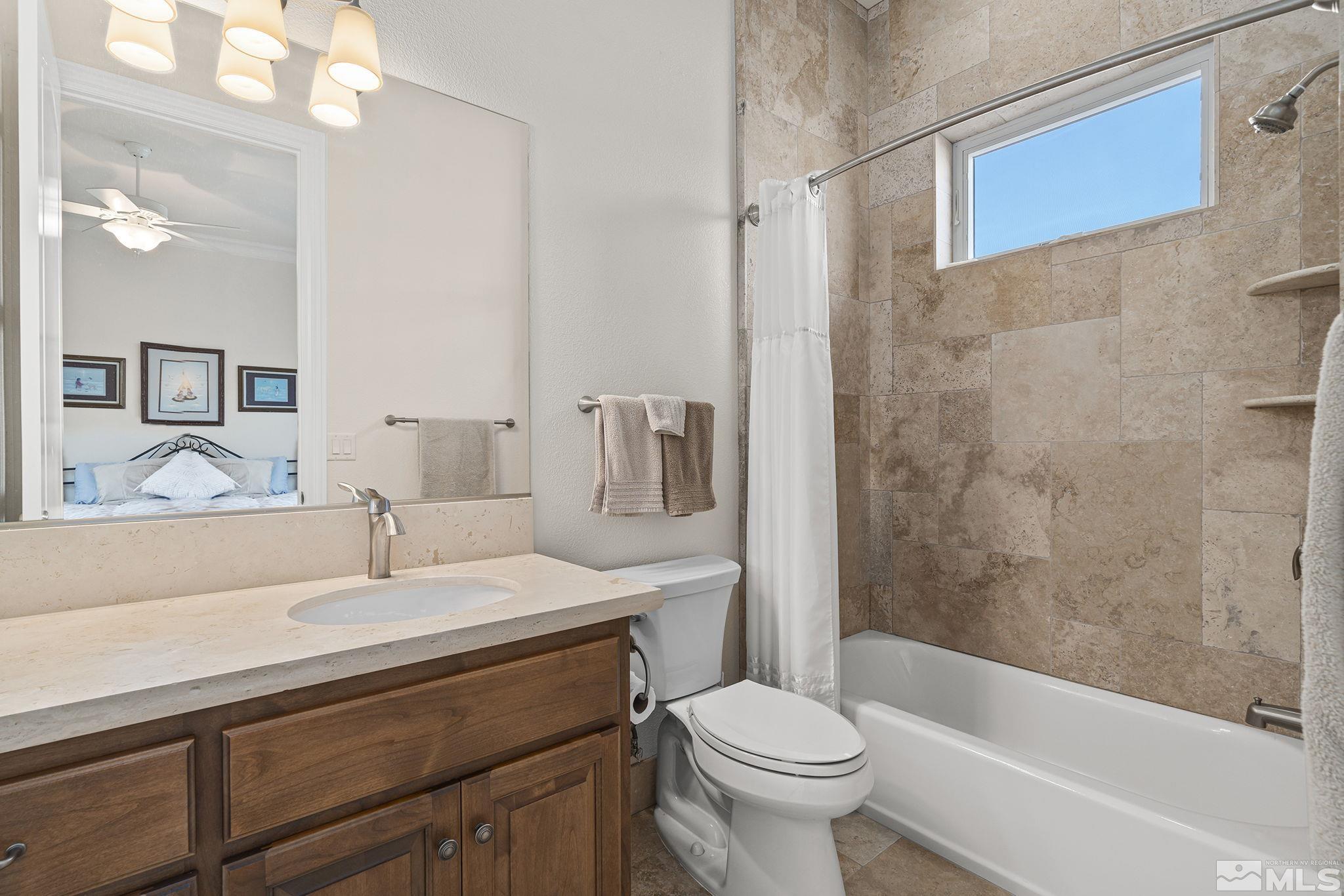 345 James Canyon Loop Genoa, NV 89411 - Photo 28 of 40 a bathroom with a sink a toilet and a bathtub