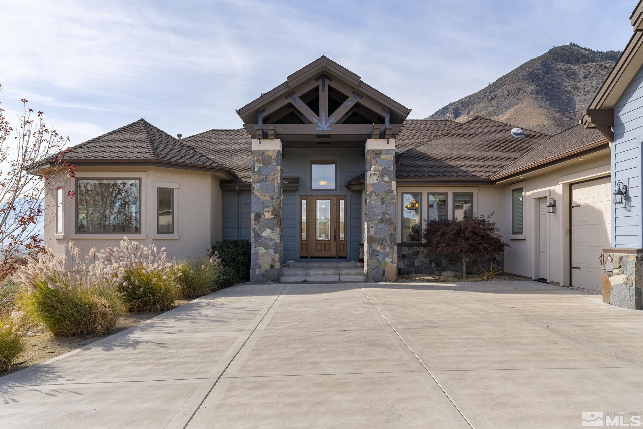 345 James Canyon Loop Genoa, NV 89411 - Photo 7 of 40 a front view of a house with a yard