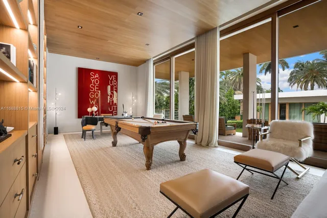 a living room with furniture a table and a large window