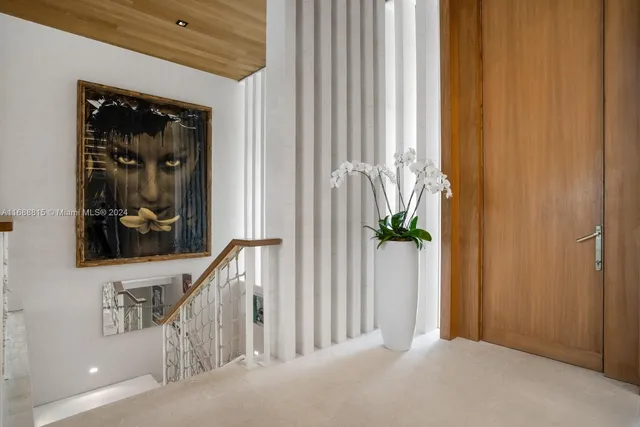 a view of a hallway with wooden floor and front door