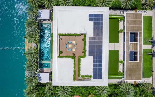 a view of a swimming pool with a lawn chairs and a big yard