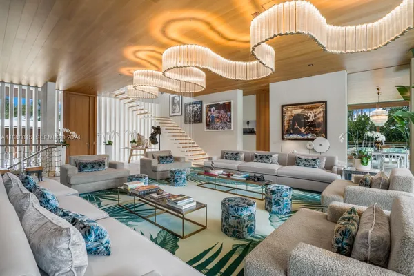 a living room with furniture and a chandelier