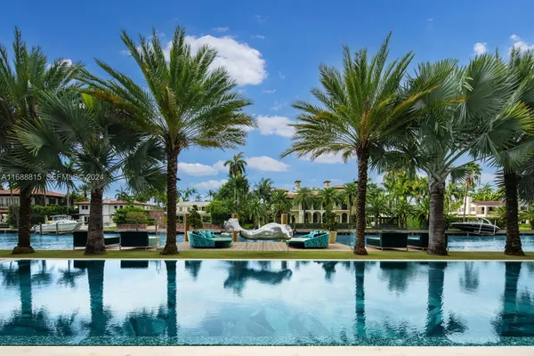 a view of swimming pool with table and chairs