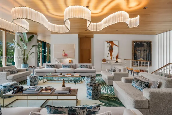 a living room with furniture chandelier and a large window