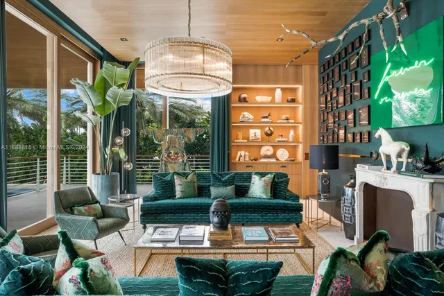 a living room filled with furniture a chandelier and a large window