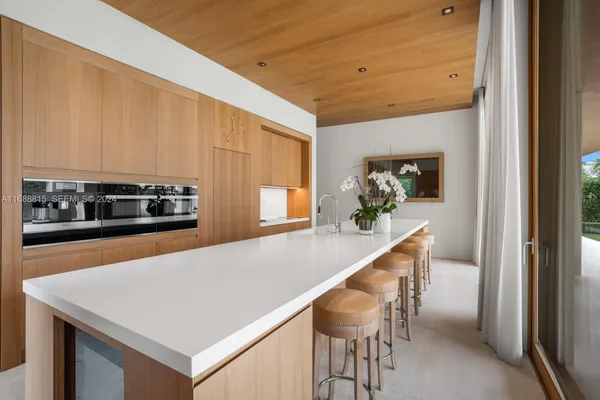 a kitchen with a table and chairs in it