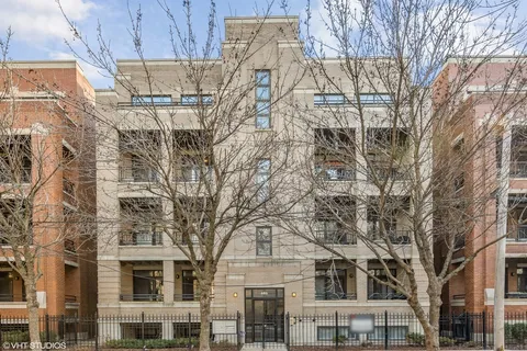a large building with a tree in front