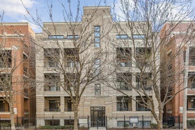 a large building with a tree in front