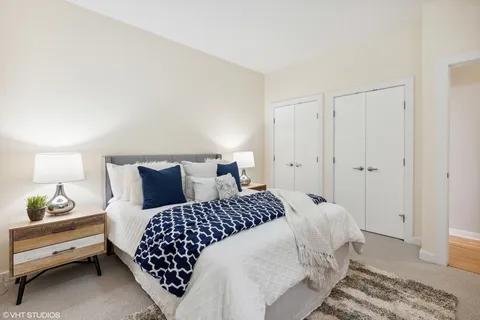 a bedroom with a bed and a lamp