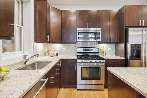 a kitchen with a sink stove and refrigerator