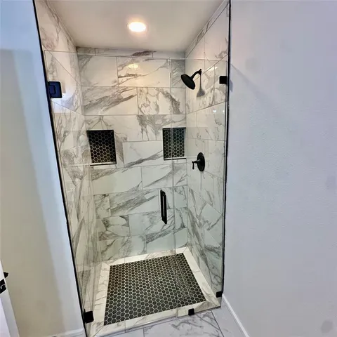 a bathroom with a granite countertop sink toilet and mirror