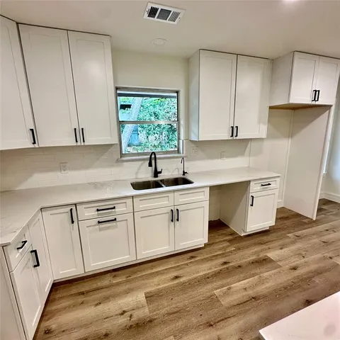 a view of a kitchen with wooden floor