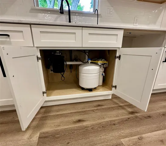 a kitchen with white cabinets and white appliances