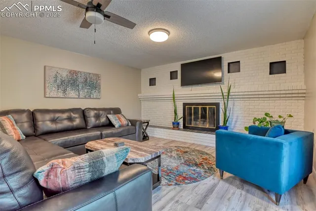 a living room with furniture fireplace and flat screen tv
