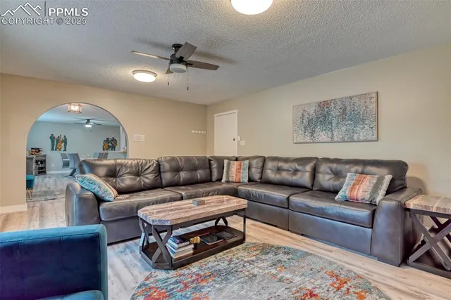 a living room with furniture and a chandelier
