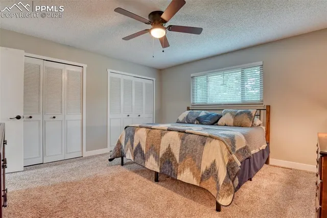 a spacious bedroom with a bed and a chandelier