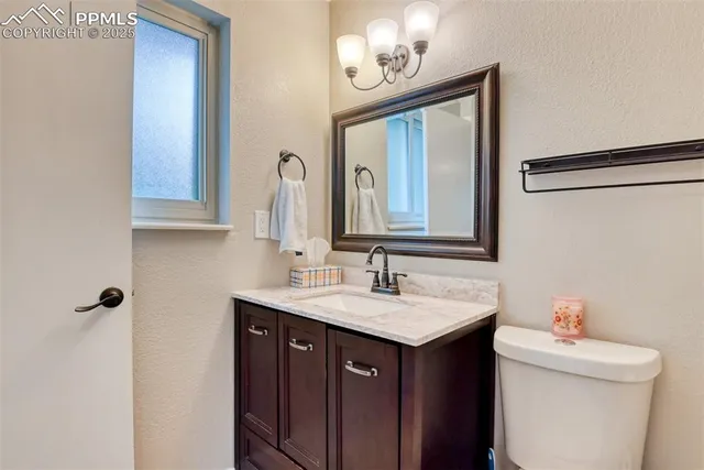 a bathroom with a sink vanity and a mirror