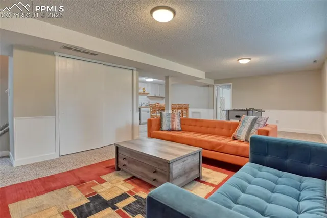 a living room with furniture and a rug