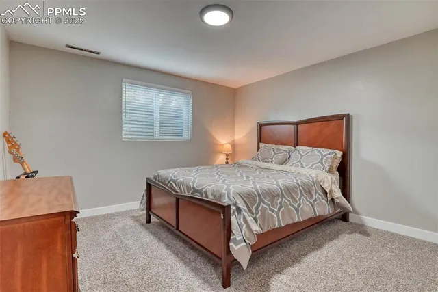 a bedroom with a bed and a refrigerator