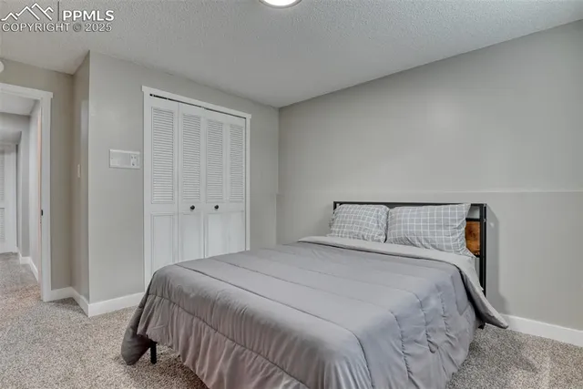 a bedroom with a bed and closet