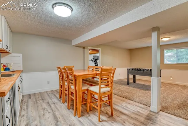 a dining room with furniture and wooden floor