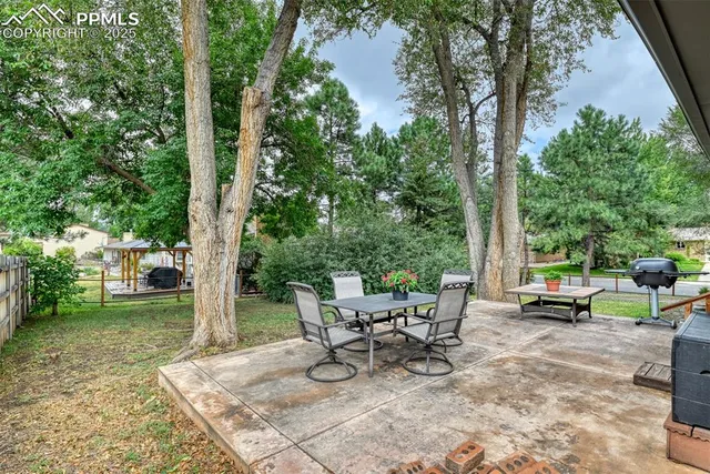 a view of a backyard with sitting area