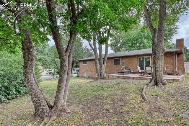 a view of a house with backyard from a patio