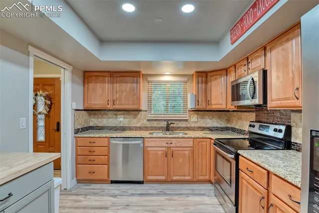a kitchen with a sink stove and cabinets